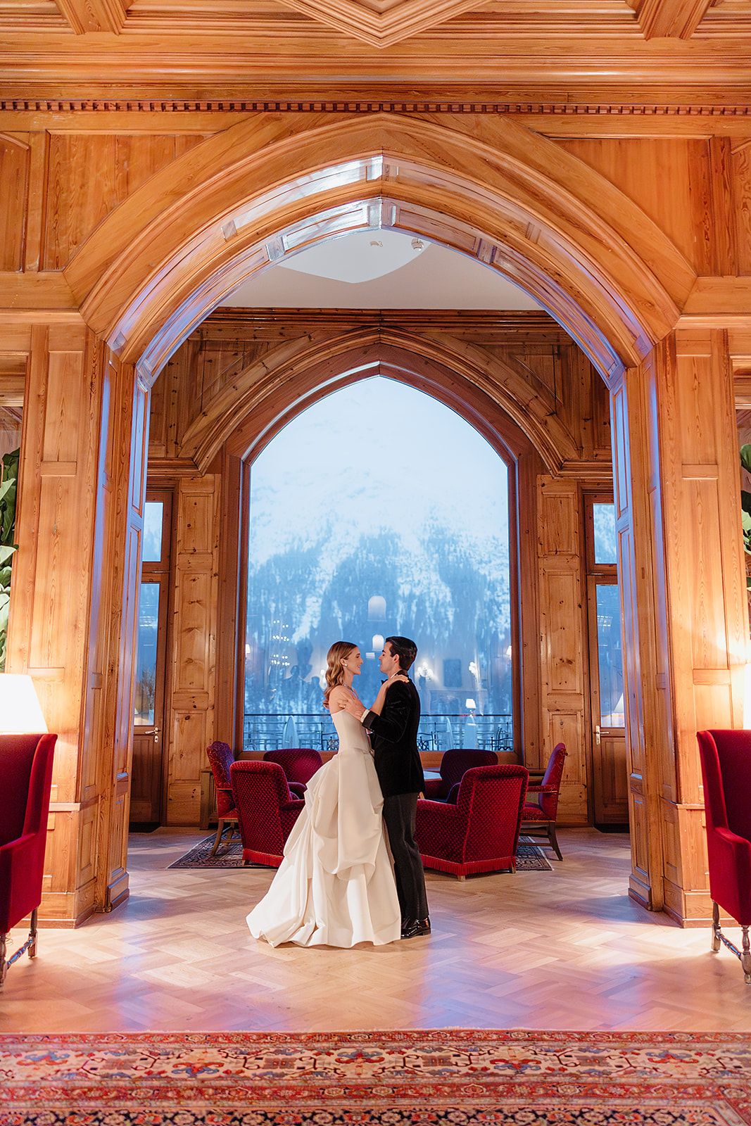 Bride and groom with view on the mountains at the old world winter wedding in Saint Moritz