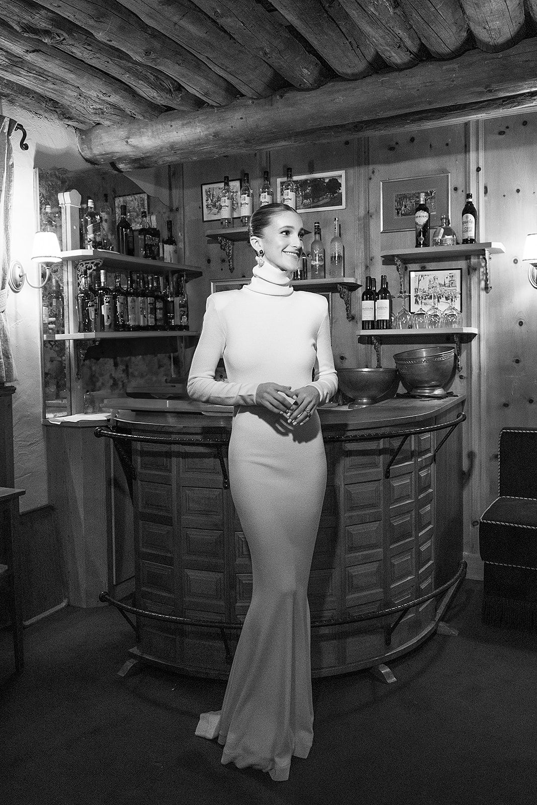 Bride in long white dress at the rehearsal dinner of old world winter wedding in Saint Moritz