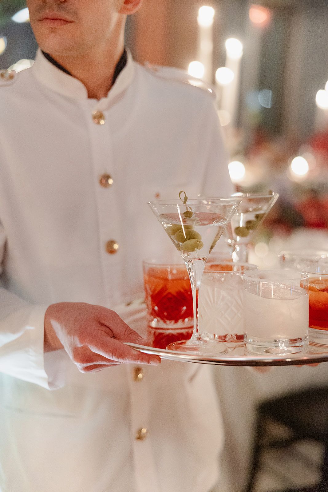 Cocktails served by waiter at the old world winter wedding in Saint Moritz