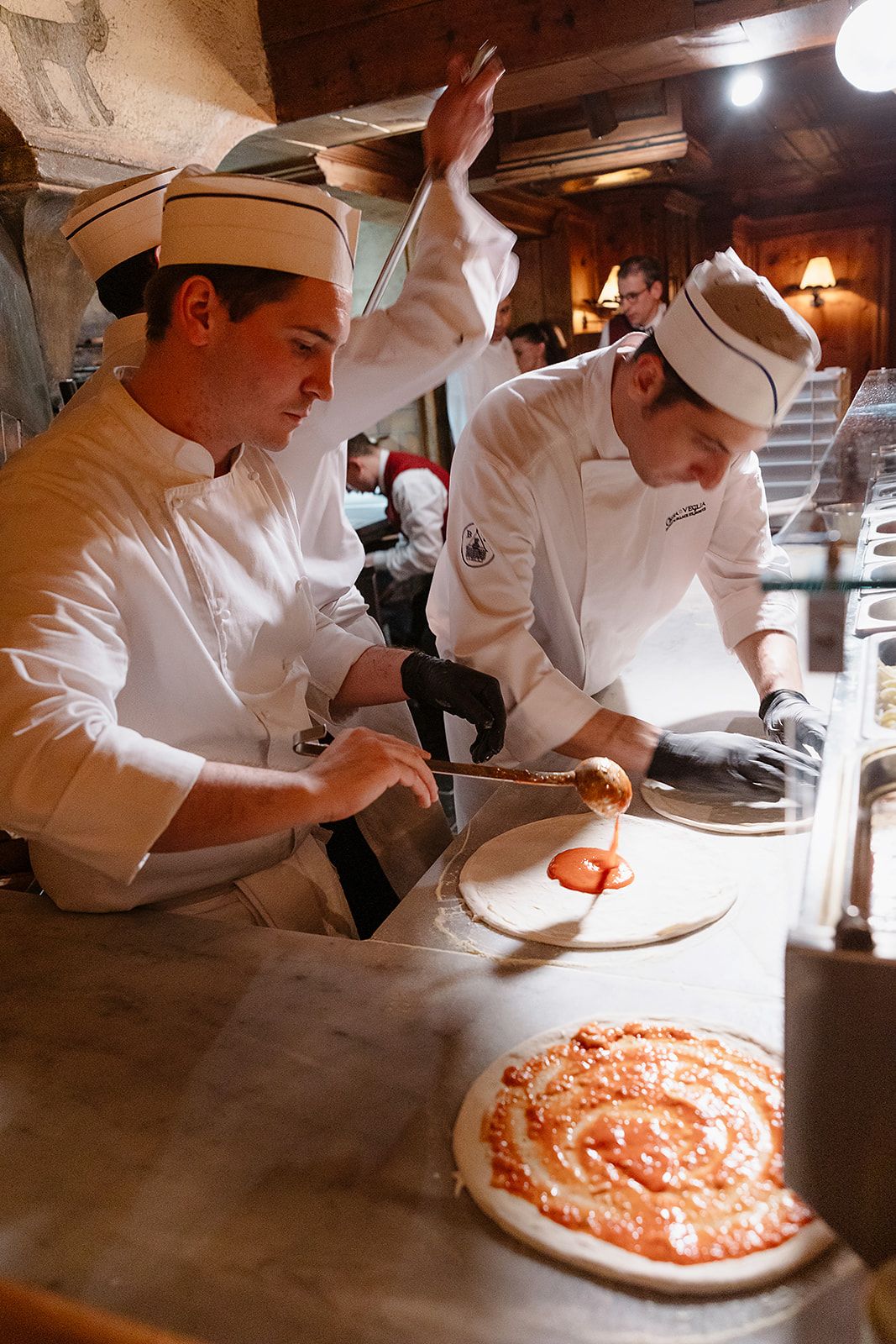 Pizza makers at the rehearsal dinner of old world winter wedding in Saint Moritz