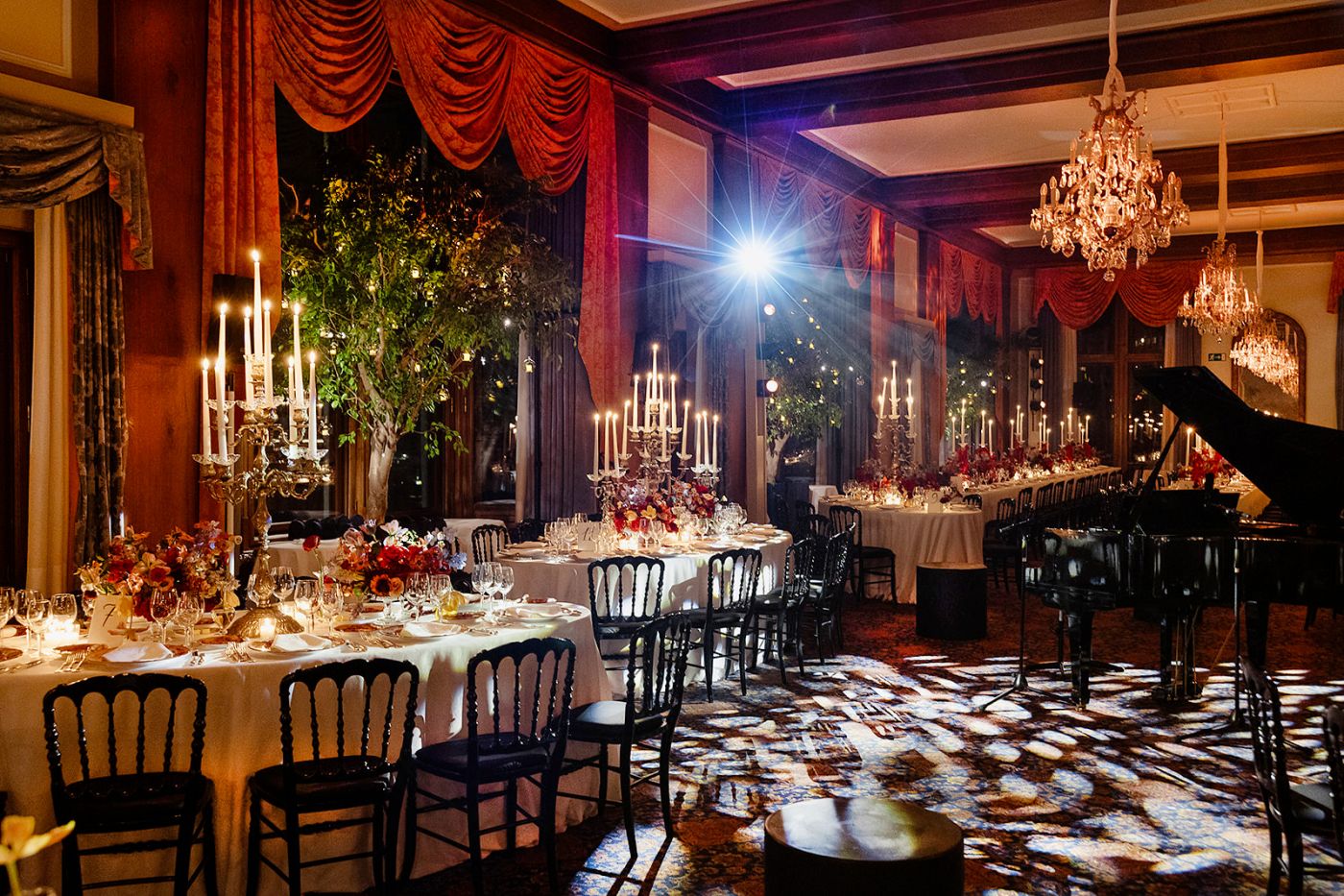 Tables with piano at the old world winter wedding in Saint Moritz