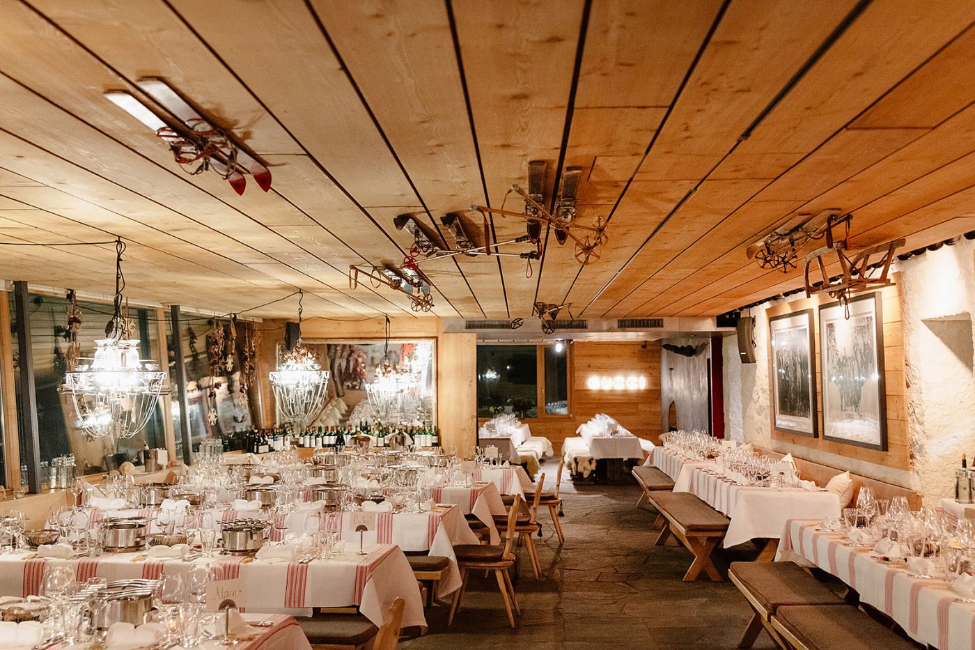 View of the main room at the welcome dinner of old world winter wedding in Saint Moritz