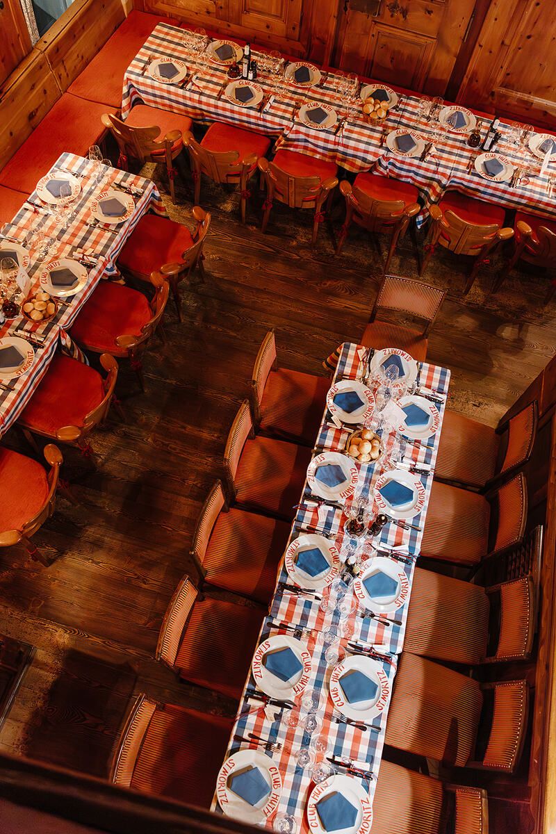 View of the tables at the rehearsal dinner of old world winter wedding in Saint Moritz